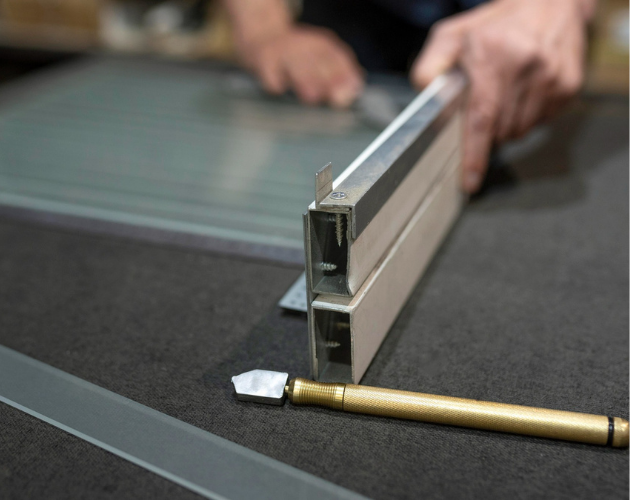 Precision glass cutting and aluminum frame assembly for custom glass installation